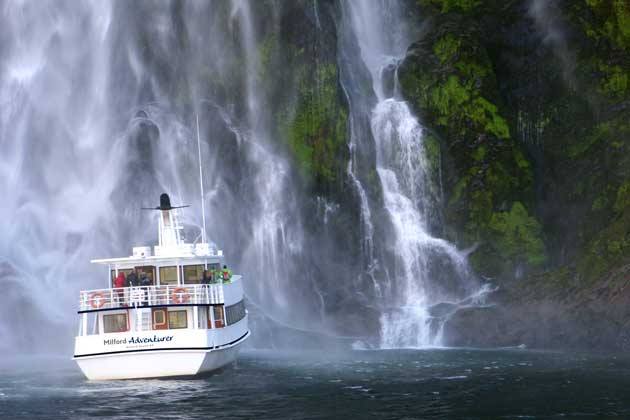 a large waterfall over some water